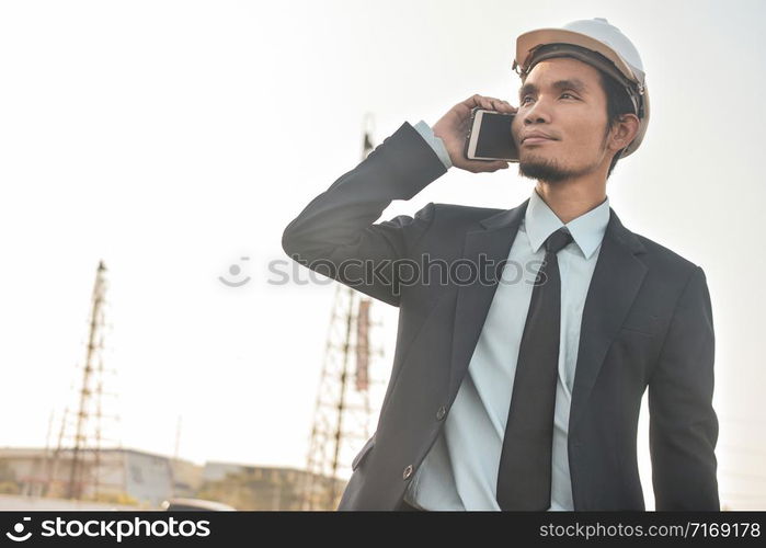 Businessman holding mobile smart phone communication building estate construction background