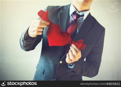 Businessman holding open armed heart with hands - warm welcome and invitation with heart concept. Businessman holding open armed heart with hands - warm welcome and invitation with heart concept.