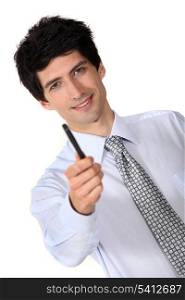 Businessman holding out a pen