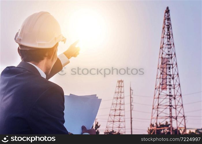Businessman holding paper work Document planing blue print working at construction building estate background