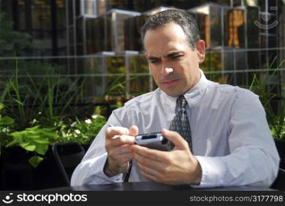 Businessman holding pda looking stressed