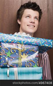 Businessman holding pile of presents
