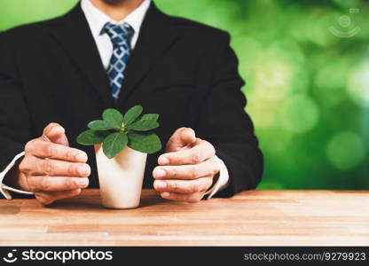 Businessman holding plant pot with his hand promoting forest regeneration and natural awareness. Ethical green business with eco-friendly policy utilizing renewable energy to preserve ecology. Alter. Businessman holding plant pot with his hand promoting forest regeneration. Alter