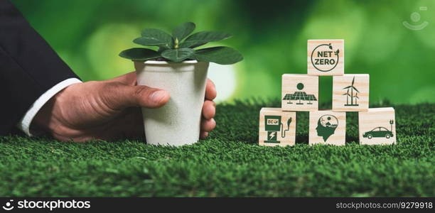 Businessman holding plant pot with Net zero cube symbol. Forest regeneration and reducing CO2 emission for natural awareness. Ethical green business with eco-friendly policy grow forest concept. Alter. Businessman holding plant pot with Net zero cube symbol. Alter