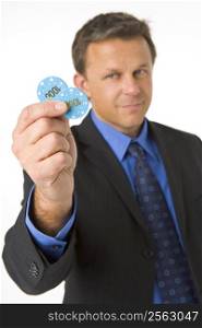Businessman Holding Poker Chips To The Value Of $2000