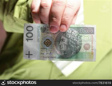 Businessman holding polish money hundred zloty banknote