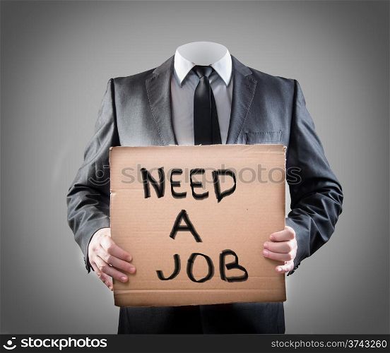 "Businessman holding sign "need a job""