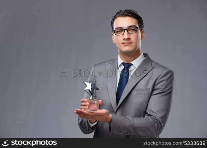 Businessman holding star award in business concept