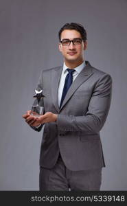 Businessman holding star award in business concept