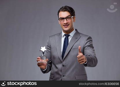 Businessman holding star award in business concept