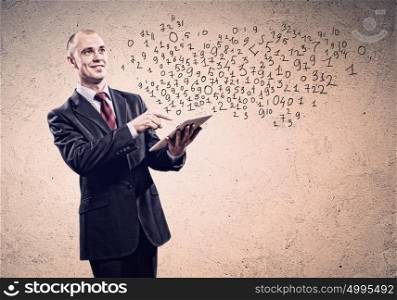 Businessman holding tablet pc. Young businessman holding tablet pc thinking over idea
