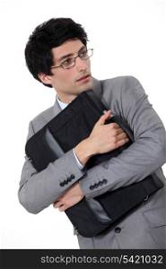 businessman holding tight his briefcase
