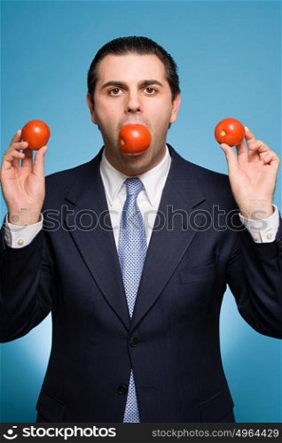 Businessman holding tomatoes