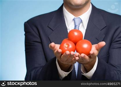 Businessman holding tomatoes