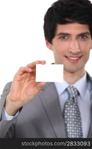 Businessman holding up a blank business card