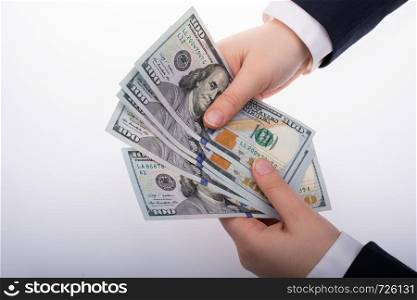 Businessman holding US dollar banknote money on white background