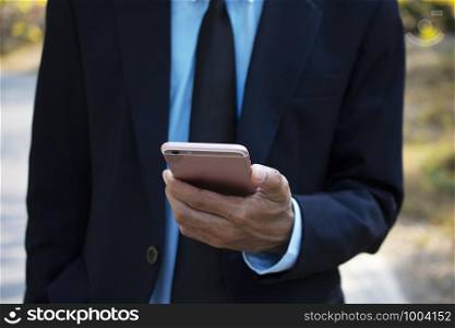 Businessman holding using mobile smart phone