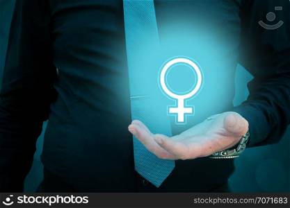 Businessman holding woman gender sign in his hand. Man taking care of a woman. Woman rights protection concept - equality. Businessman holding woman gender sign in his hand. Man taking care of a woman. Woman rights protection concept