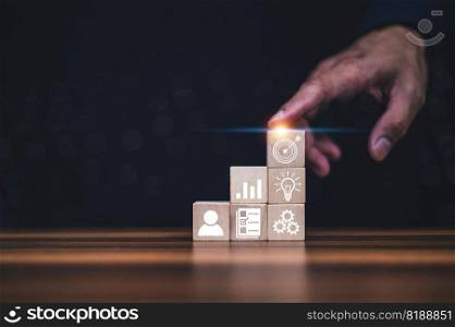 Businessman holding wood block stacking with business strategy and Action plan, targeting the business concept. business development concept.