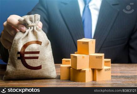Businessman holds euro money bag and boxes with goods. Purchase and sale of goods, trade and commerce. Import and export. Payment of taxes and fees. Advertising budget. Business income.
