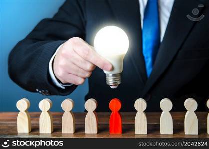 Businessman holds idea light bulb over employee. Search for recruiting talent. Professional job candidates. Employment of talented workers. Identifying people with skills, leadership qualities