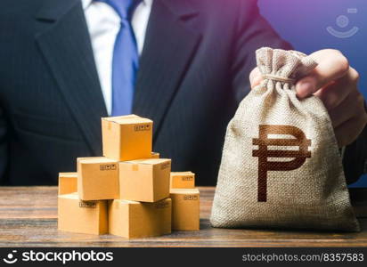 Businessman holds philippine peso money bag and boxes with goods. Purchase and sale of goods, trade. Import and export. Business income. Payment of taxes and fees. Advertising budget