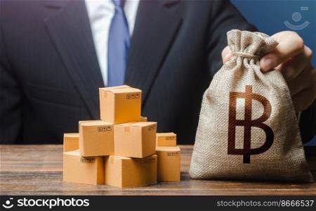 Businessman holds thai baht money bag and boxes with goods. Import and export. Business income. Payment of taxes and fees. Purchase and sale of goods, trade and commerce. Advertising budget