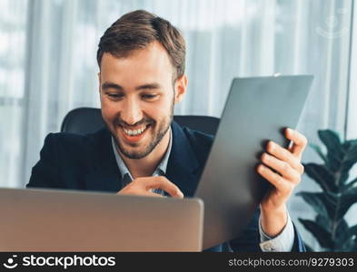 Businessman holds virtual office meeting from office desk, discussing with online video conference using webinar application on laptop for distant communication with remote workers. Entity. Businessman holds virtual online office meeting from office desk. Entity