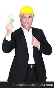 Businessman in a hardhat holding a 100 euro note
