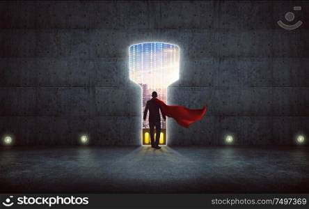 Businessman in a suit and cape hero stand on wall with digital usb key hole door ,smart city skyline outdoor view .