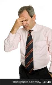 Businessman in a suit gestures with a headache