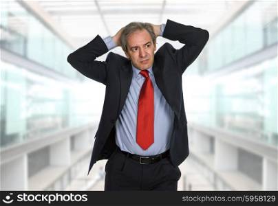 Businessman in a suit gestures with a headache