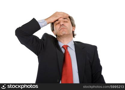 Businessman in a suit gestures with a headache