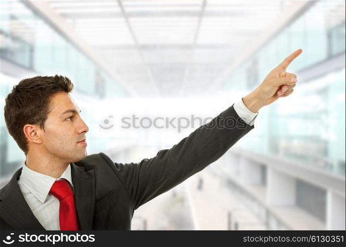businessman in a suit pointing with his finger, at the office