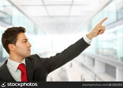 businessman in a suit pointing with his finger, at the office