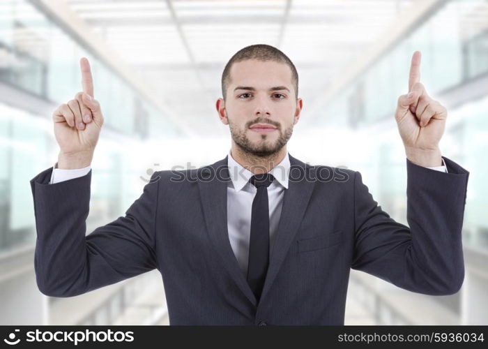 businessman in a suit pointing with his fingers, at the office