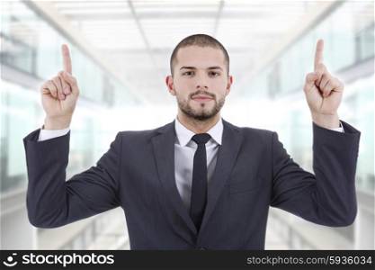 businessman in a suit pointing with his fingers, at the office