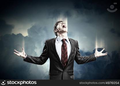 businessman in anger. businessman in anger screaming against cloudy background