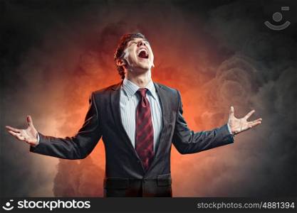 businessman in anger. businessman in anger with fists clenched screaming
