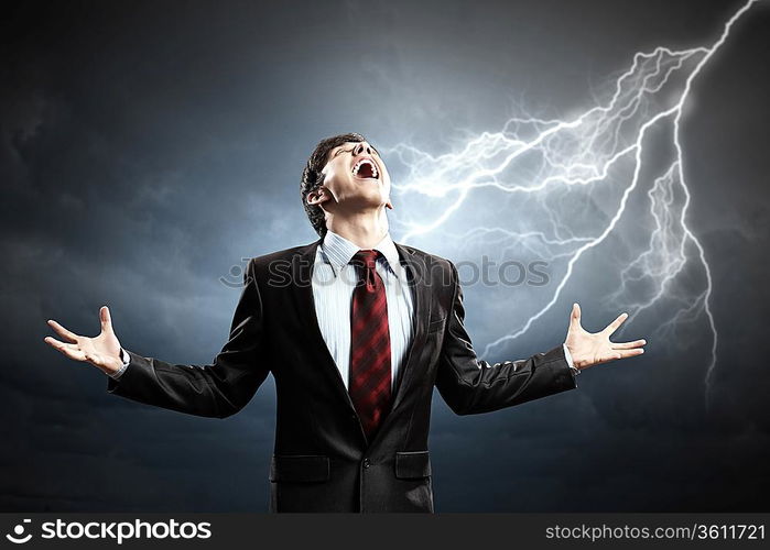 businessman in anger with fists clenched screaming