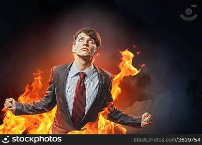 businessman in anger with fists clenched screaming