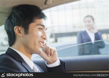 Businessman in Back Seat of Car on the Phone, Close Up
