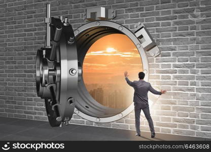 Businessman in banking concept with vault door