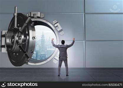 Businessman in banking concept with vault door
