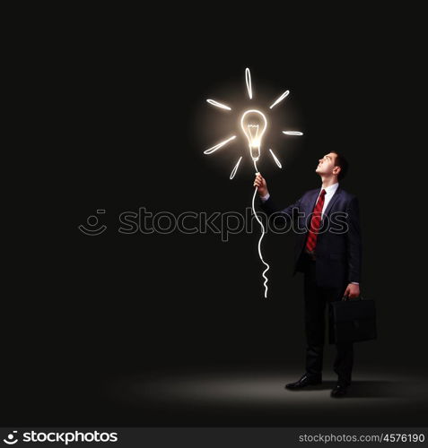 Businessman in black suit. Image of businessman in black suit against dark background