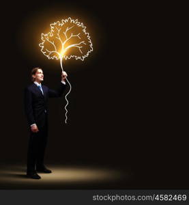 Businessman in black suit. Image of businessman in black suit against dark background