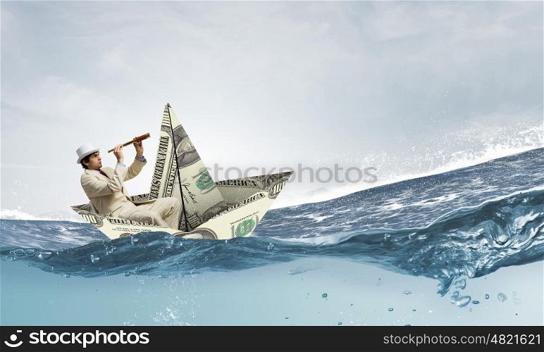 Businessman in boat made of dollar banknote. Successful businessman sailing on dollar boat in financial sea