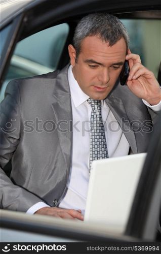 Businessman in car talking on phone