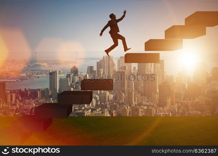 Businessman in career promotion concept with stairs