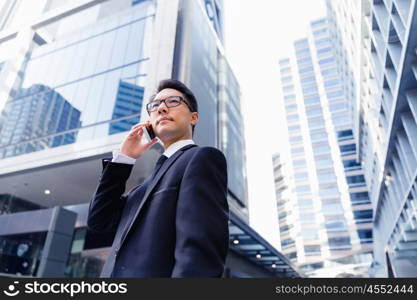 Businessman in city holding his mobile. Technology is a part of my life